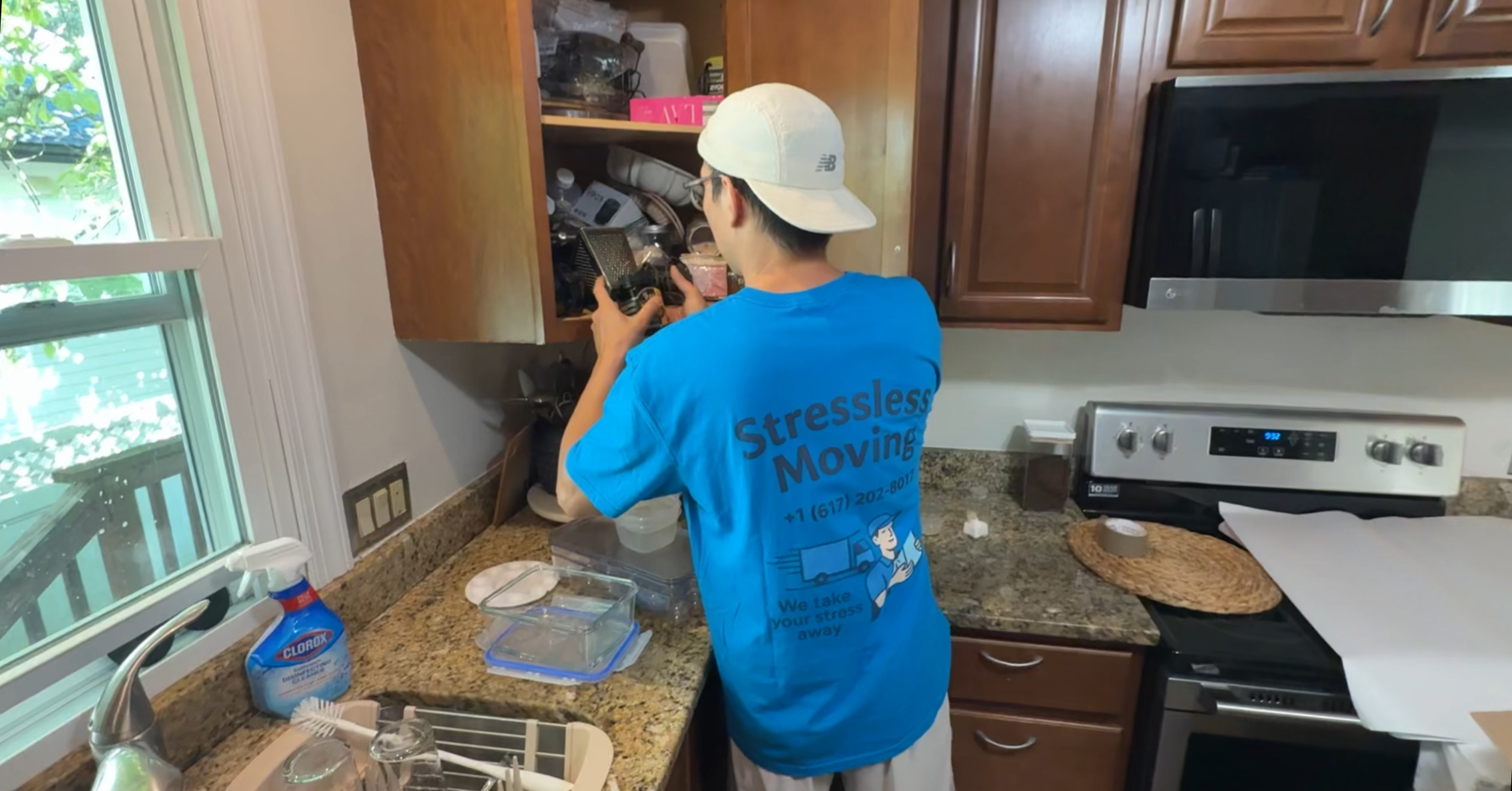 Stressless Moving team member packing items in a kitchen Boston moving company